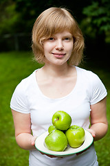 Image showing Girl holding fresh green apples