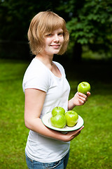 Image showing Girl holding fresh green apples