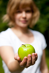 Image showing Girl holding a fresh green apple