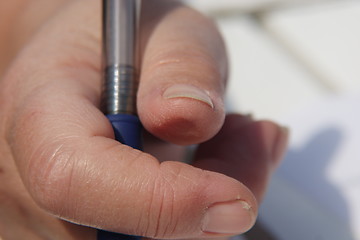 Image showing Fingers with pencil