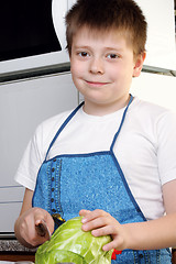 Image showing Smiling boy with cabbage