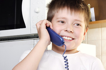 Image showing Boy in white talking phone