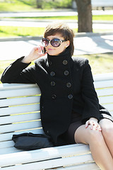 Image showing Cute woman in park talking on cellphone