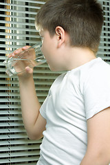 Image showing Boy in white drinking water