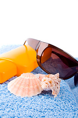 Image showing towel, shells, sunglasses and lotion