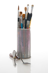 Image showing Paintbrushes in a metal mesh holder