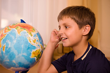 Image showing boy looking globe of world 