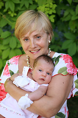 Image showing Grandmother outdoors on patio with baby