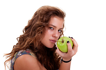 Image showing Beautiful girl eating a green apple