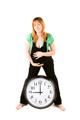 Image showing pregnant woman with a clock