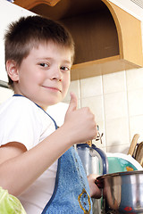 Image showing Contented boy at kitchen