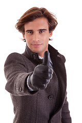 Image showing Portrait of a young businessman with thumb up, in autumn/winter clothes