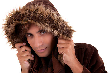 Image showing Portrait of a young man with a furry hood , in autumn/winter clothes