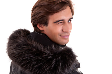 Image showing Portrait of a young man winking from back, in autumn/winter clothes