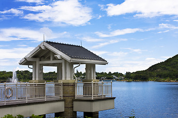 Image showing Beautiful spring lake and wooden belvedere in the park.