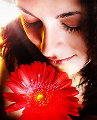 Image showing Girl with a red flower