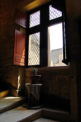 Image showing Open window on stairs with plant