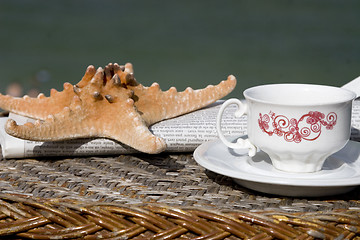 Image showing coffee cup, newspaper and starfish