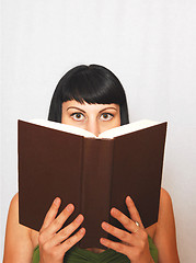 Image showing Young woman reading a book.