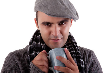 Image showing Portrait of a young man, drinking a hot drink in autumn/winter clothes