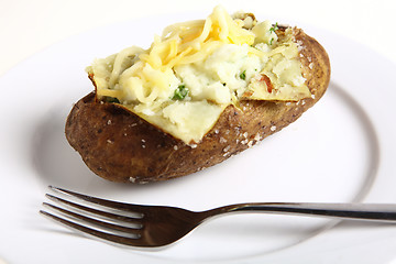 Image showing Baked potato with fork on plate