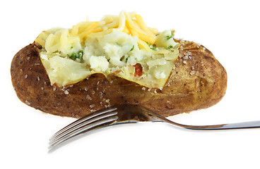 Image showing Baked potato with fork isolated