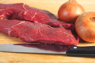 Image showing Raw steak and onions