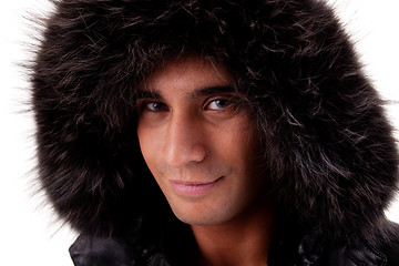 Image showing Portrait of a young man with a furry hood , in autumn/winter clothes