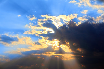 Image showing storm clouds and sun behind