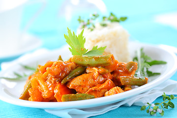 Image showing Red chicken curry stripes with rice