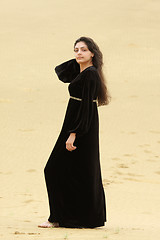 Image showing Young woman in desert sideview