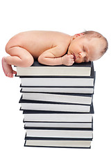 Image showing newborn sleep on pile of books