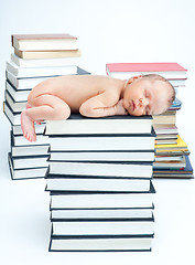 Image showing New born baby sleep on books