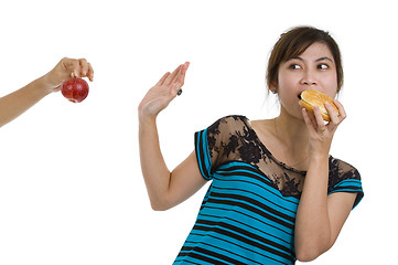 Image showing woman with hamburger refusing an apple