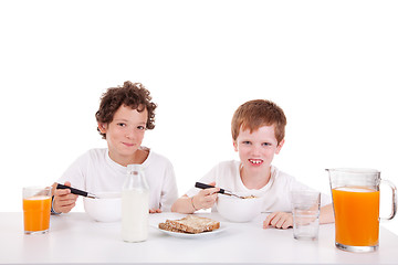 Image showing cute boys taking breakfast, isolated on white