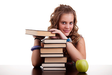 Image showing happy beautiful girl , with a stack of books, and a apple,