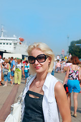 Image showing Young woman in sunglasses on  sea port 