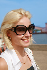 Image showing Young woman in sunglasses on  sea port