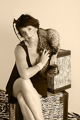 Image showing portrait of Woman with fur sitting on the box. retro. 30s of the