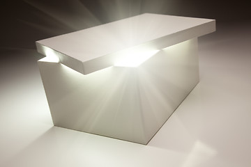 Image showing White Box with Lid Revealing Something Very Bright