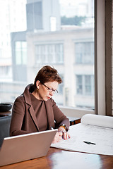 Image showing Businesswoman writing on a paper