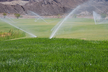 Image showing sprinklers on golf course