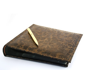 Image showing The golden pen with an album