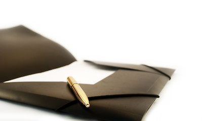 Image showing The golden pen with a black folder