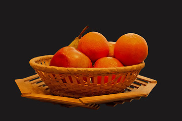 Image showing The isolated basket with oranges, an apple and a pear