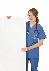 Image showing Friendly nurse holding blank banner