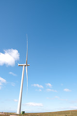 Image showing Single wind turbine against blue sky