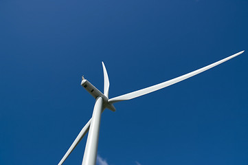 Image showing Wind turbine close up in deep blue sky