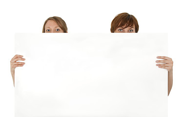 Image showing Two young women behind a blank banner ad