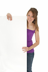 Image showing Casual young women holding a blank banner ad